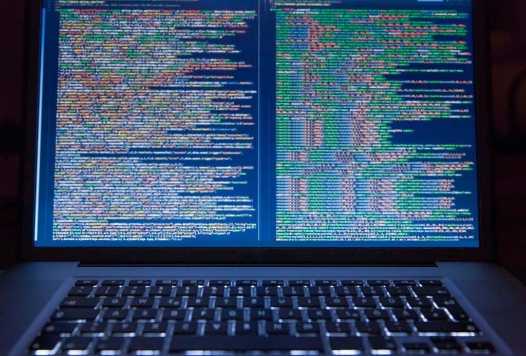 A laptop screen filled with lines of code